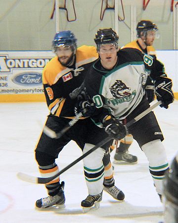 Tim Dwinnell (R) of the Wolves, maintains his position in front of the Milverton net, waiting for the puck